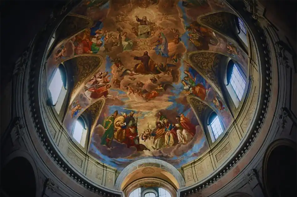 Ornate church dome ceiling with colourful frescoes depicting religious figures and scenes, surrounded by arched windows letting in natural light.